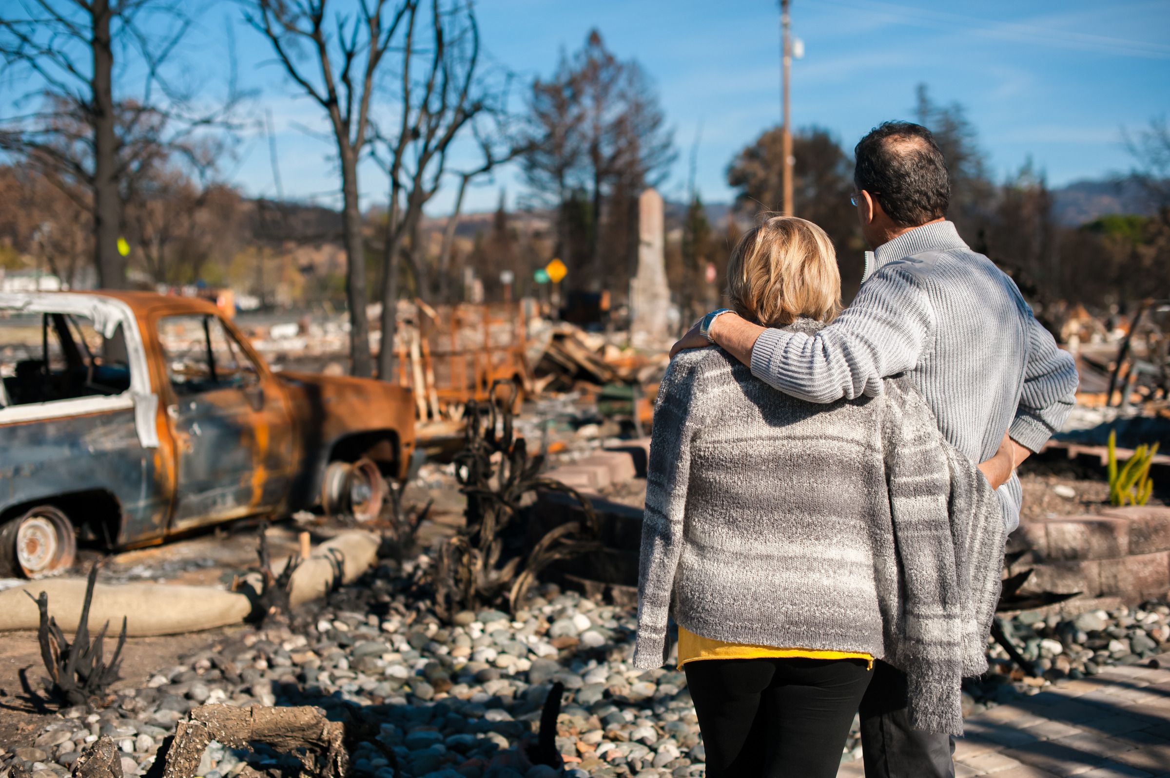 Picuture of couple in front of house fire
