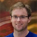 Man with short light brown hair and glasses